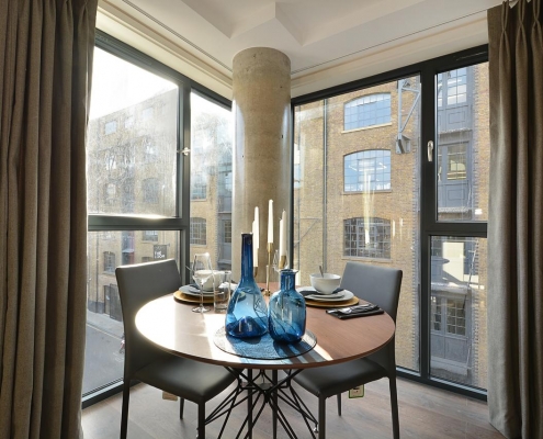Modern apartment building exterior with glass balconies and sleek design